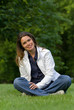 Pretty brunette relaxing on a fresh grass in a park Pretty brunette relaxing on a fresh grass in a park