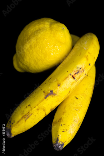 Two ripe yellow bananas and lemon