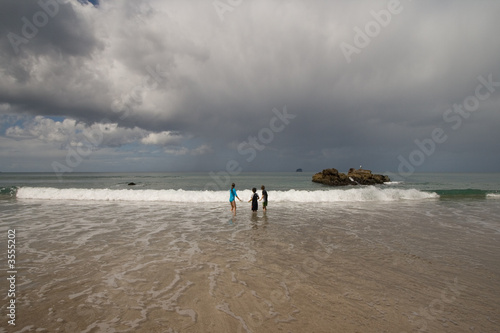 Photo: Children playing on New Zealand beach Children playing on New Zealand beach