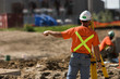 Construction surveyor giving directions.
