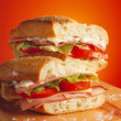 Tasty ham and tomato sandwich on a wooden table