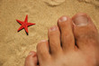 Red star and toes on sand
