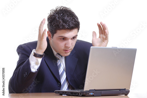 Shocked businessman working on a laptop