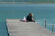 A couple of adults sitting on a pontoon