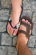 Two feet in Slippers on the pavement