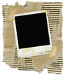 Ripped corrugated cardboard with polaroid and tape.