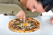 Pretty lady showing on egg on the pizza