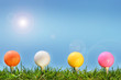 Colored golf balls in the grass