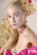 Girl with make-up as beside dolls