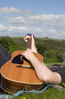 Man strums guitar on a sunny day