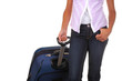 Photo: Woman in jeans pulling suitcase isolated over white Woman in jeans pulling suitcase isolated over white