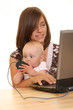 mother and 8 months baby girl working together