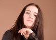 Woman in black portrait isolated on beige background