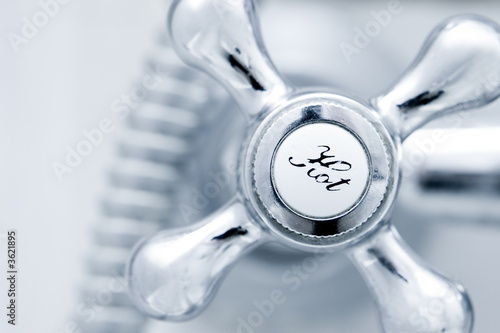 Photo: Bath tap with hot sign close up Bath tap with hot sign close up