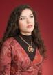 Woman in dress portrait isolated on red background