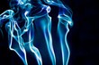 blue and purple smoke against black background