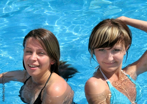 Two happy girls in pool