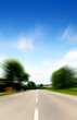 moving fast on a road in a beautiful landscape on a sunny day