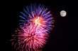 A fireworks display and a full moon.