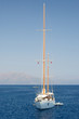 Solitary Yacht at sea against mountains Solitary Yacht at sea against mountains