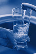 Pouring Fresh Tap Water Into a Glass. Shallow DOF. Focus on Tap. Pouring Fresh Tap Water Into a Glass. Shallow DOF. Focus on Tap.