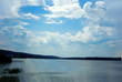 Small Lake amongst the woods, cloudy summer sky.