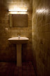 Old bathroom. Natural red tint from light and old walls.