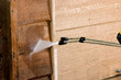 The side of a garage being pressure washed
