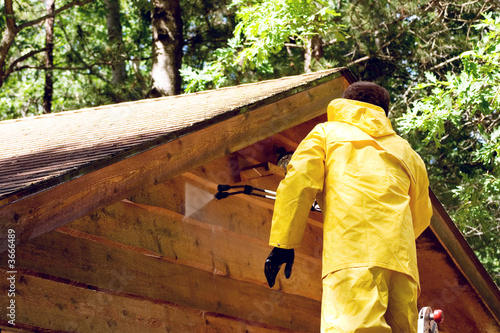 Photo: a man pressure washing a wood sided garage a man pressure washing a wood sided garage