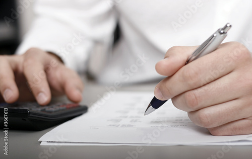 A businessman calculating expenses at tax time