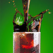 Pouring a cola in glass with a splash