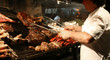 Argentinian chef cooking meat in the restaurant