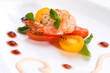 Closeup of spicy grilled shrimps and basil tomato salad served.