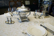beautiful antique table setting with silver soup bowl