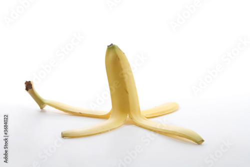 Photo: A banana peel over a white background A banana peel over a white background