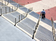Elderly man descending concrete stairs