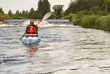 Female kayaker paddling on River Dee in Wales 