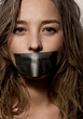a woman's mouth sealed with a scotch tape