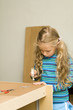 Girl helping to assemble a new furniture Girl helping to assemble a new furniture
