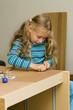 Girl helping to assemble a new furniture Girl helping to assemble a new furniture