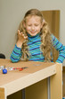 Girl helping to assemble a new furniture Girl helping to assemble a new furniture