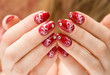 Red woman nails with decorations.