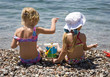 Two girls sitting on the shore of sea 2 Two girls sitting on the shore of sea 2