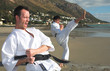 Young adult men with black belt practicing a Kata 