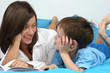 mother and five years old boy reading book - good night mother and five years old boy reading book - good night