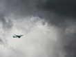 Jumbo jet over cloudy sky.