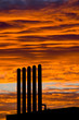 Backlit chimneys against fiery red dawning