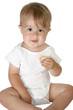 Adorable baby boy sitting up eating sandwich