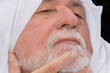 older middle-eastern man with white beard,