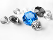 Blue gemstone among colorless gemstones